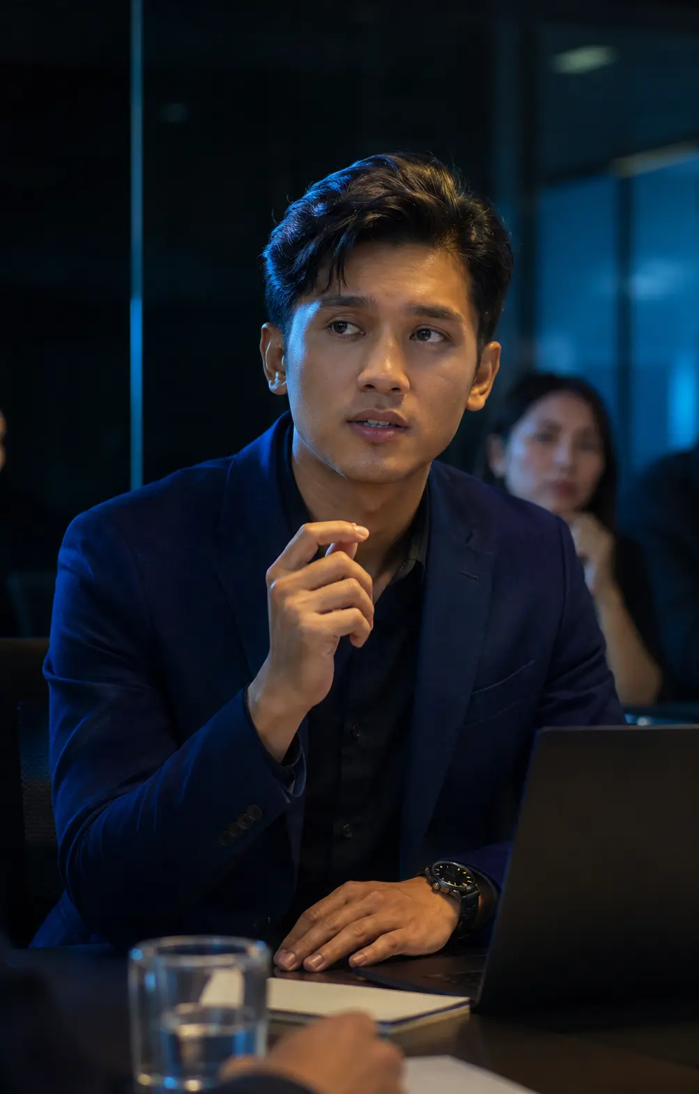 Young Malaysian professional preparing to communicate in a workplace setting