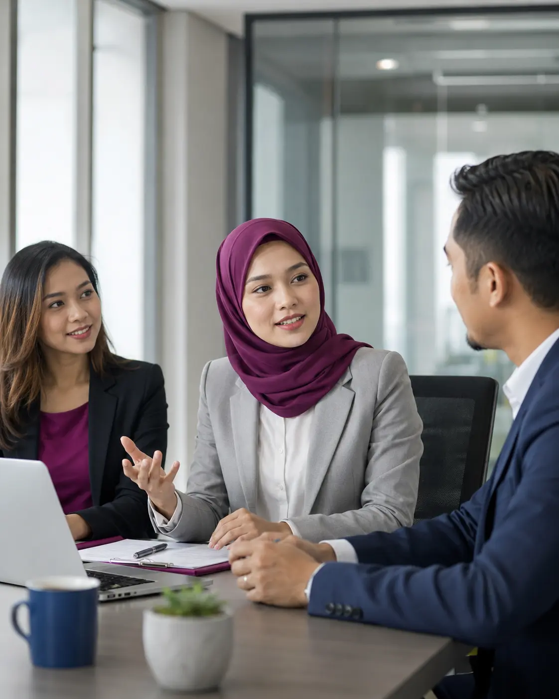 Malaysian professionals communicating clearly at work
